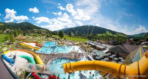 an aerial view of a water park with a water slide at Berghoam - inklusive Wasserwelt in Wagrain