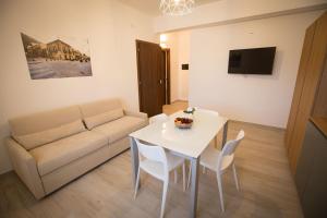 a living room with a white table and a couch at Casa Vacanza Barone in Castellammare del Golfo