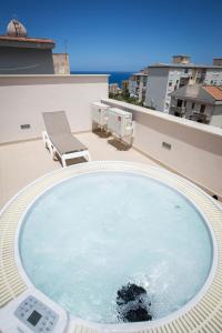 a large swimming pool on the roof of a house at Casa Vacanza Barone in Castellammare del Golfo