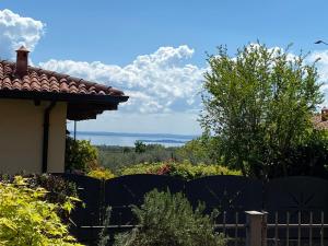 a fence in front of a house with a view at B&B Nonna Cecilia in Puegnago