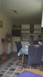 a kitchen and dining room with a table and chairs at Sandsteinperle in Reinhardtsdorf +11 photos