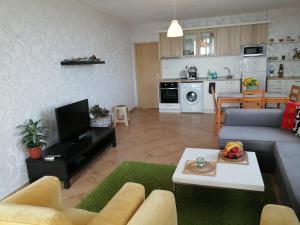 a living room with a couch and a table at Apartments Del Sol - Sunny Island Complex in Chernomorets
