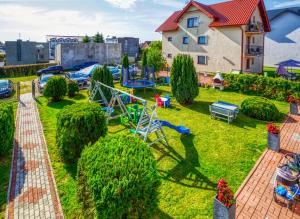 a yard with a playground and a house at Albatros in Władysławowo