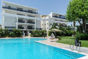 a swimming pool in front of a building at ROYAL PARK -George in Eilat