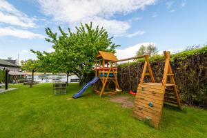 a playground in a yard with a slide at Willa ATA Mikolajki in Mikołajki