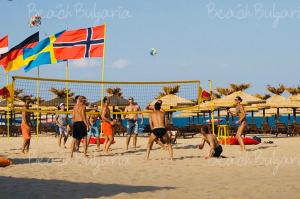 a group of people playing volleyball on the beach at Апартамент Франческа in Varna City