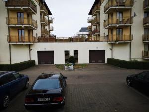 a car parked in a parking lot in front of a building at Apartament Edyta in Świnoujście