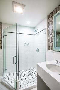 a bathroom with a glass shower and a sink at University Club of San Francisco in San Francisco +32 photos