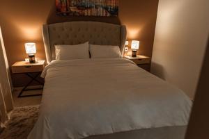 a bedroom with a large bed with two night stands at ROYAL PARK -George in Eilat +32 photos