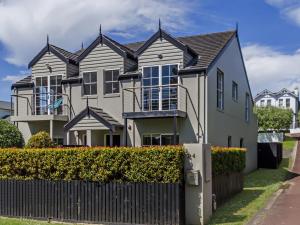 a large house with a fence in front of it at Elizas Townhouse in Port Fairy