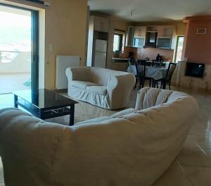 a living room with a couch and a table at MARMARI Village in Ayía Marína +16 photos
