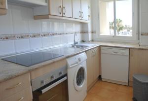 a kitchen with a sink and a washing machine at Great 2 Bedroom Apartment Near Puerto Banus in Marbella
