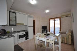 a kitchen with a table and a dining room at SweetHome Fabio&Stefy in Guidonia