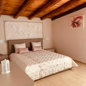 a bedroom with a large bed with pink pillows at Casa Vacanze Belvedere in Partinico