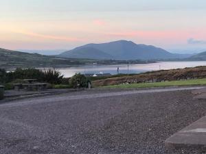 a road with a view of a river and mountains at Skellig Port Accomodation - 2 Bed Apartment in Portmagee