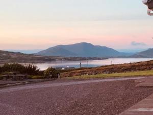 a road with a view of a lake and mountains at Skellig Port Accomodation - 2 Bed Apartment in Portmagee