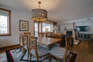 a dining room and living room with a table and chairs at The Blake at Taos Ski Valley in Taos Ski Valley