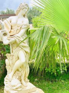 a white statue of a woman holding a bird at Casa Vacanze Belvedere in Partinico