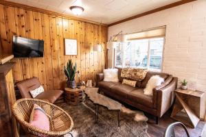 a living room with a couch and chairs at Lake Front Cabins in June Lake