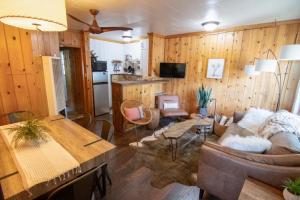 a living room filled with furniture and appliances at Lake Front Cabins in June Lake