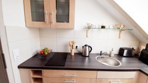 a kitchen with a sink and a counter top at Sam's Place in Kreuzwertheim