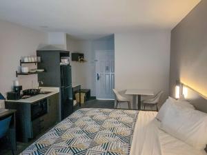 a hotel room with a bed and a kitchen at Studio 6 San Angelo, Tx in San Angelo