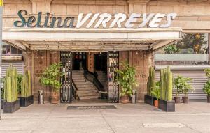 a entrance to a store with potted plants in front at Selina Mexico City Downtown in Mexico City