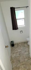 a bathroom with a toilet and a window at Blue Coast Inn & Suites in Brookings