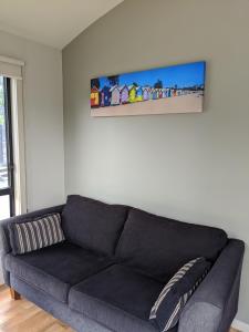 a living room with a couch and a bookcase at BIG4 Aireys Inlet in Aireys Inlet