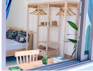 a room with a bunk bed and a room with a mirror at Xoài Xanh Hostel & Villa in Vung Tau