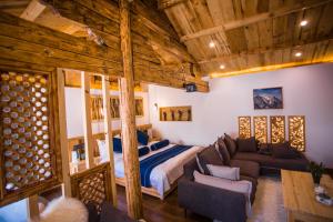 a bedroom with a bed and a couch at Lijiang Yunqi Holiday Guesthouse in Lijiang