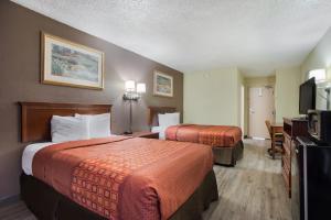 a hotel room with two beds and a flat screen tv at Americas Best Value Inn Tulsa I-44 in Tulsa +41 photos