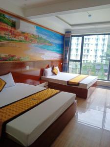 Giường trong phòng chung tại Thang Loi Tam Dao Hotel