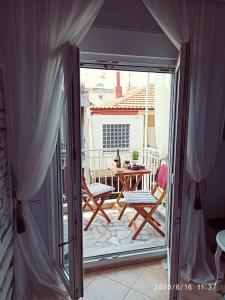 an open door to a patio with a table and chairs at Apartment Marina 2 in Asprovalta