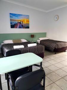 a living room filled with furniture and a couch at Sunseeker Motel in Hervey Bay