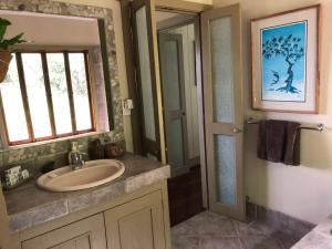 a bathroom with a sink and a window at daintree valley cottage in Daintree +71 photos