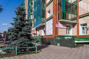 a christmas tree in front of a building at OK! Советская 98 №1 in Tomsk