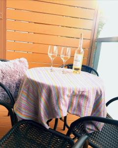 a table with two glasses and a bottle of wine at Sunset in Dziwnów