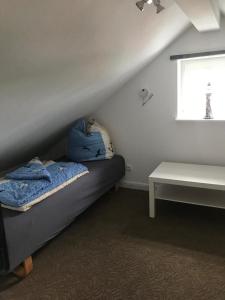 a bedroom with a bed and a window and a table at Ostseeperle in Grömitz