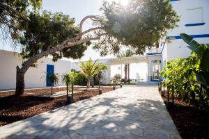 a walkway in front of a white building with trees at Bungalows Mar Menor, paz a orillas del mar in San Javier