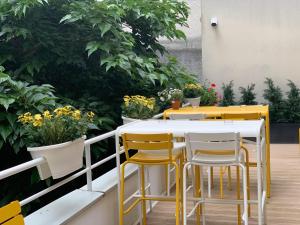 a table and chairs on a balcony with plants at Holiday Inn Paris Montmartre, an IHG Hotel in Paris