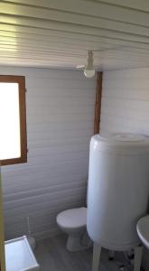 a white bathroom with a toilet and a sink at Le Chal Adret in Cardonville