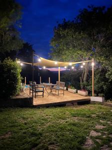 a patio with two benches and lights at night at Villa Edera in San Venanzo