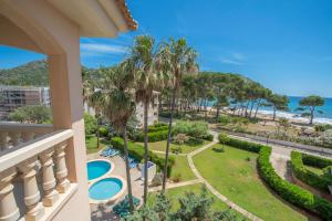 a view of the beach from a balcony of a resort at Oros de Malasigeni Bl. III 3ºA in Canyamel