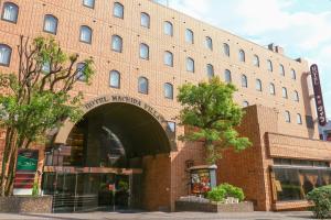 a large brick building with an archway in front of it at Hotel Machida Villa in Machida