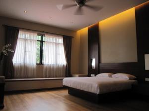 Katil atau katil-katil dalam bilik di Tropical Home