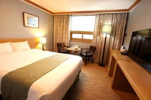 Ένα ή περισσότερα κρεβάτια σε δωμάτιο στο Prime Tourist Hotel