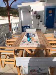 a wooden table and chairs on a balcony at Traditional House of Diafani in Karpathos