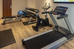 a gym with several tread machines and a treadmill at City Lodge Hotel Durban in Durban