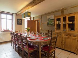 comedor con mesa de madera y sillas en Pleasant holiday home with garden in Ciney, en Ciney